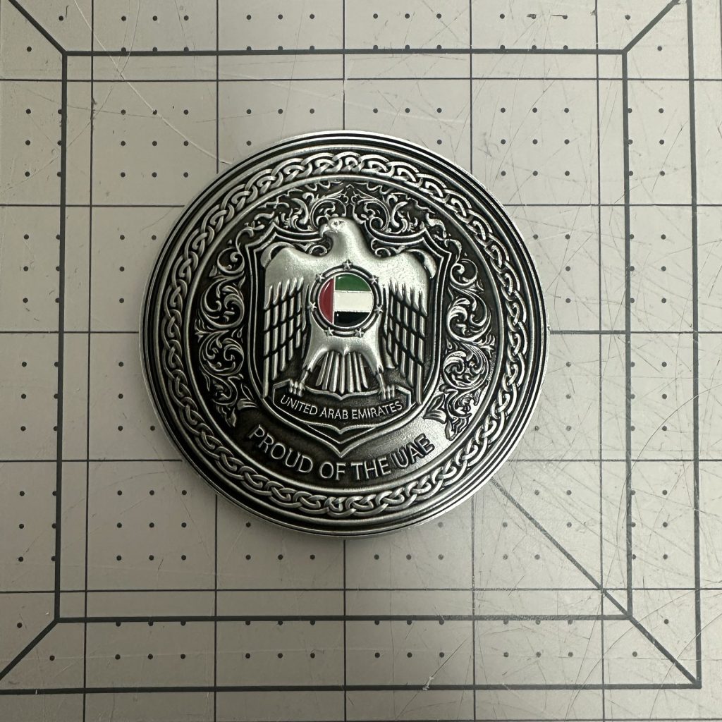 Custom challenge coin with antique silver plating and UAE falcon emblem