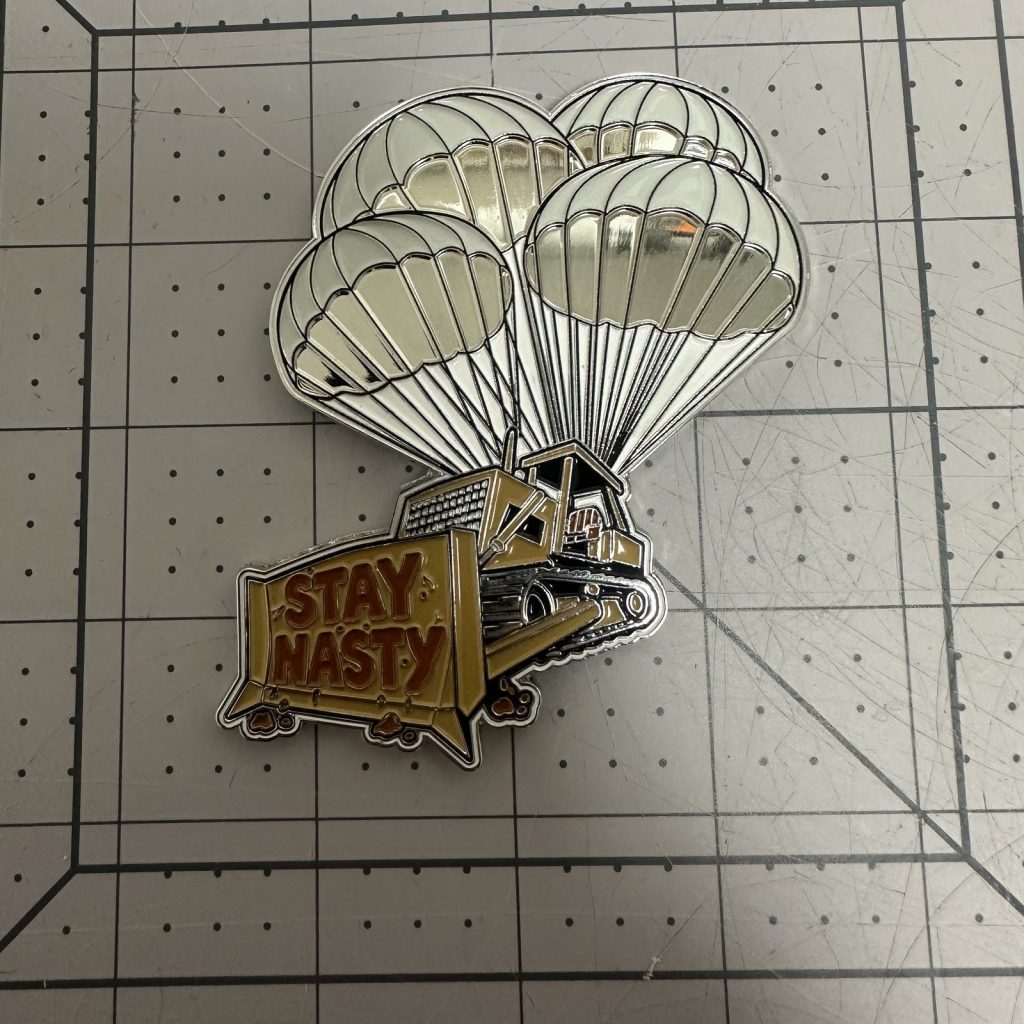 Custom die-cut shaped challenge coin with parachute artwork