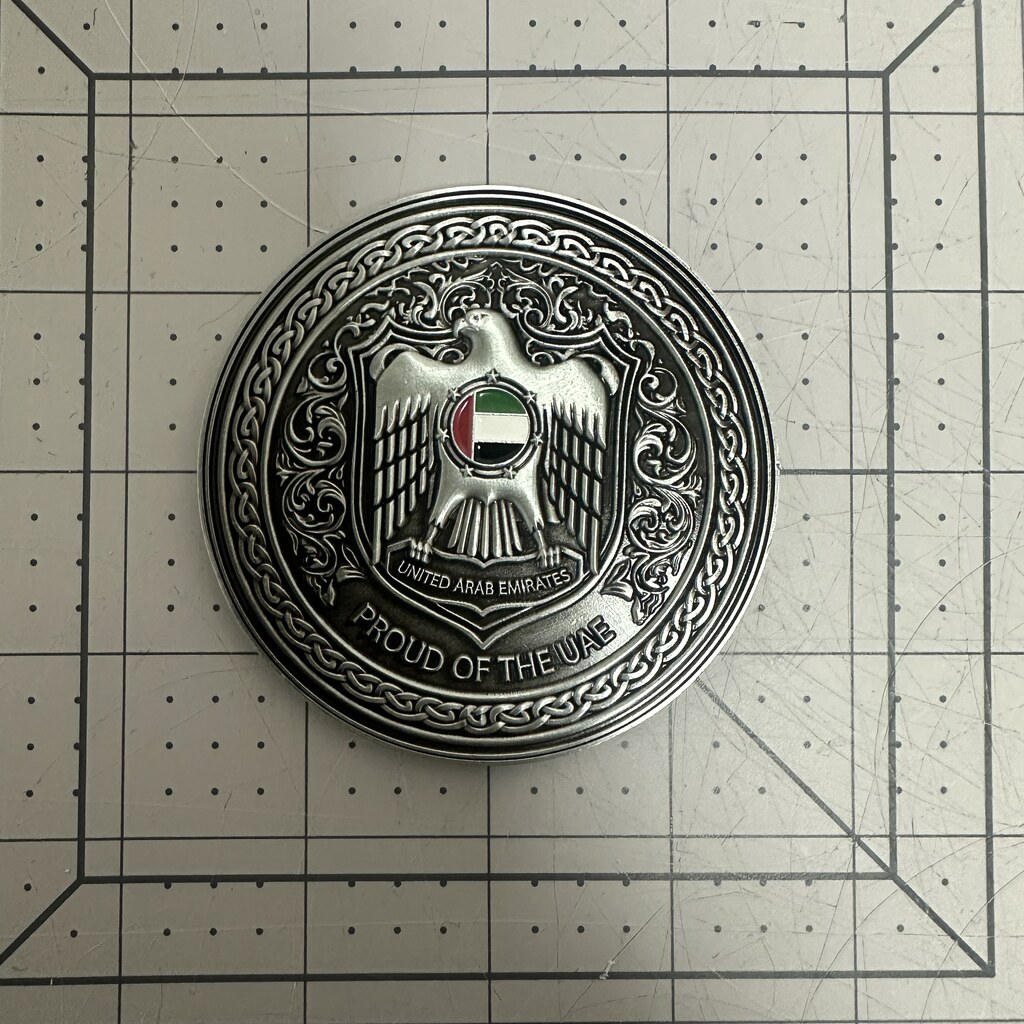 Custom challenge coin with gold plating and blue enamel ring
