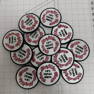 Batch of custom embroidered round patches with merrowed borders