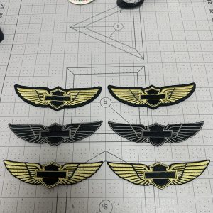 Custom embroidered wing badges in gold and black