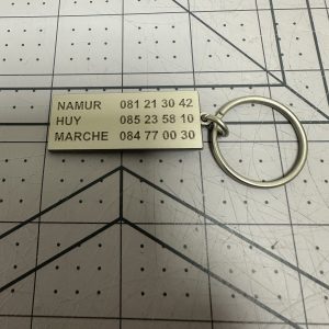 Custom brushed metal keychain tag with engraved detail