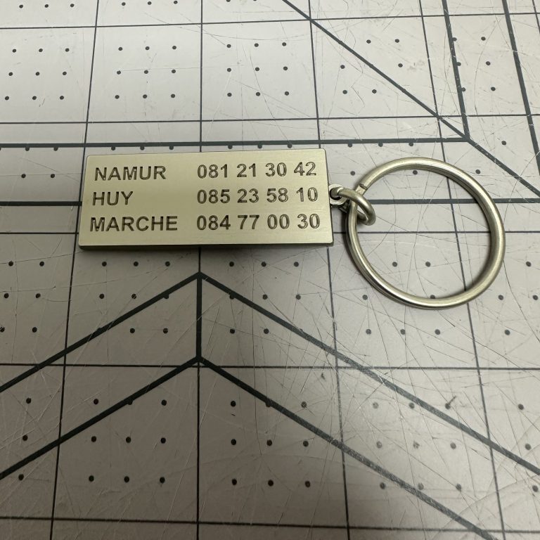 Custom brushed metal keychain tag with engraved detail
