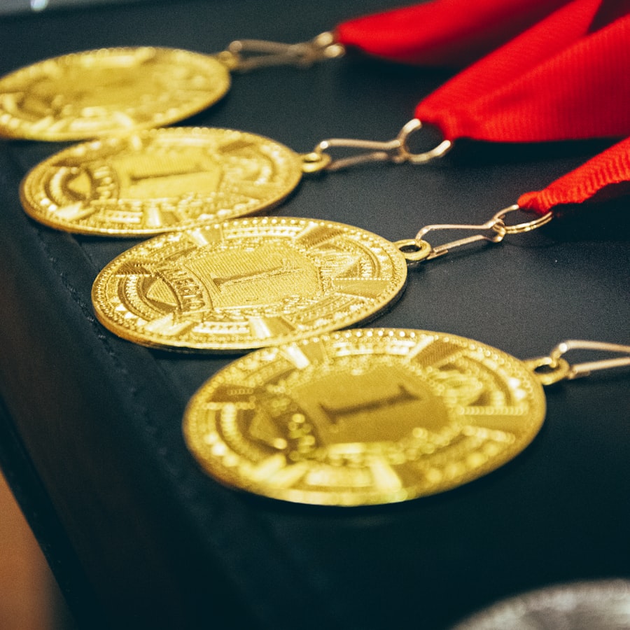 Row of custom struck gold award medals on red ribbons